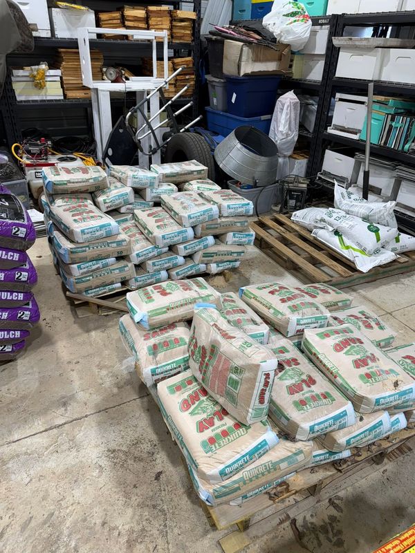 Bags of pine bark and potting mix stacked for the grafts