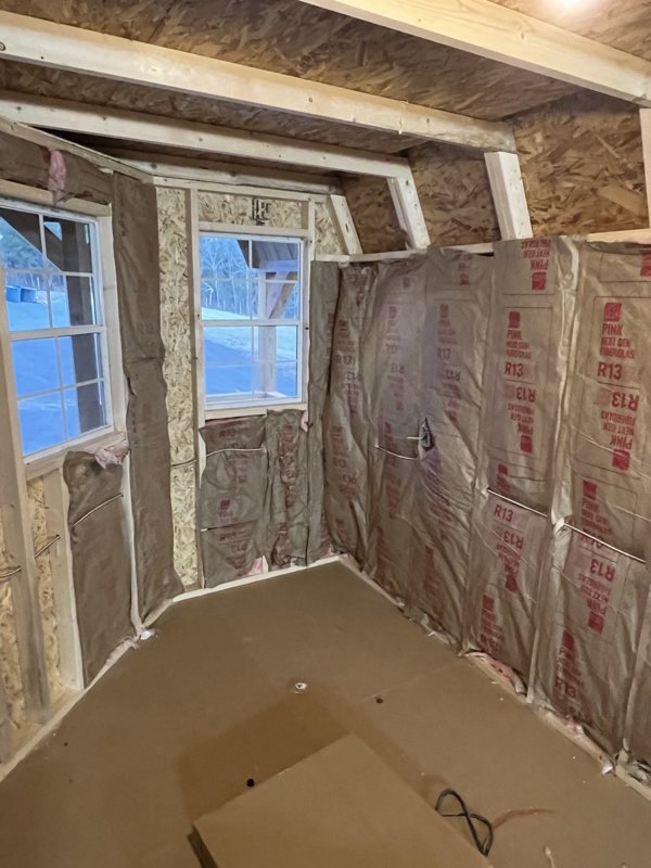 Insulation going into the walls of the unfinished honey house
